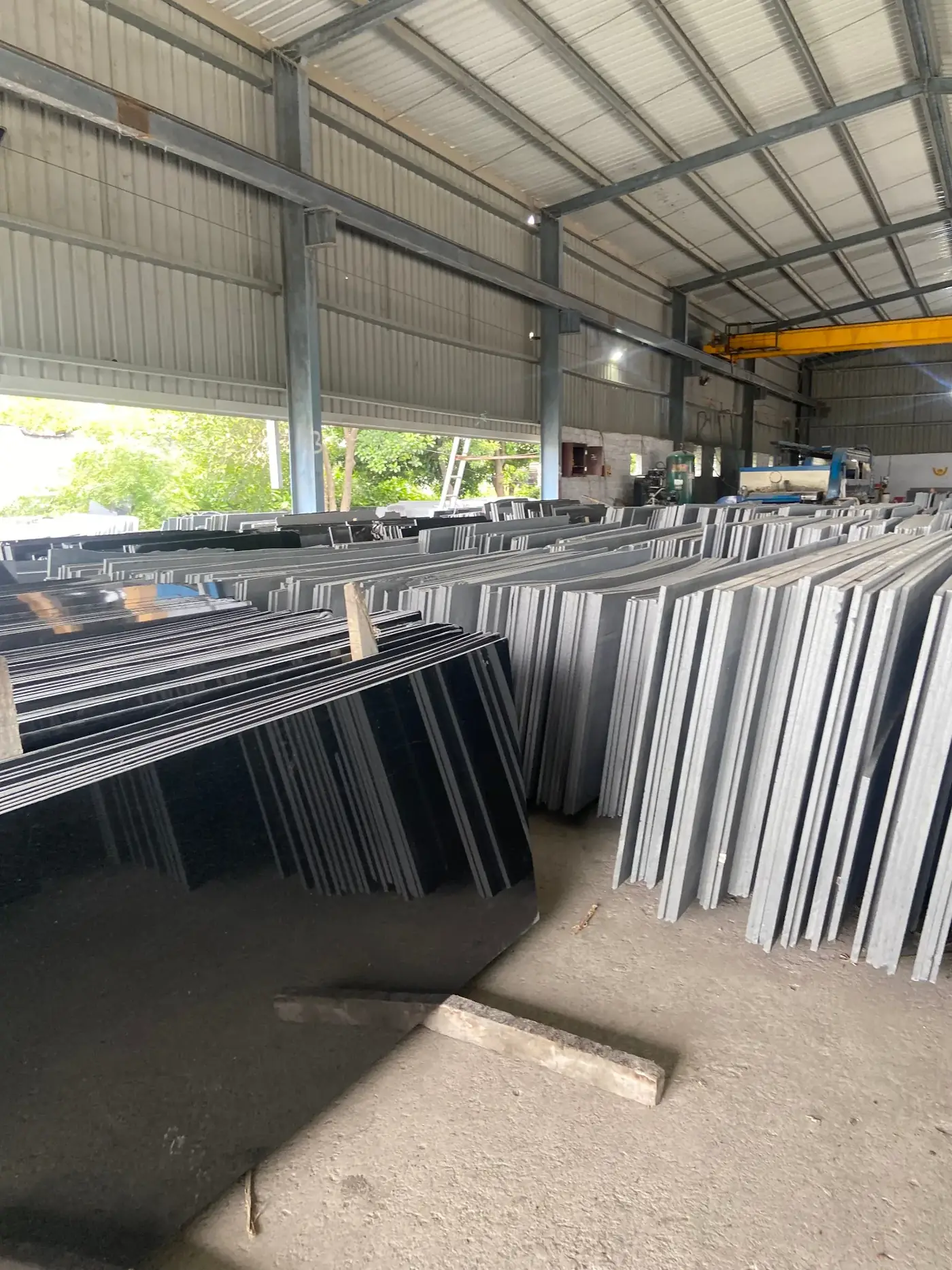 Wide view of Absolute Black granite inventory inside the factory