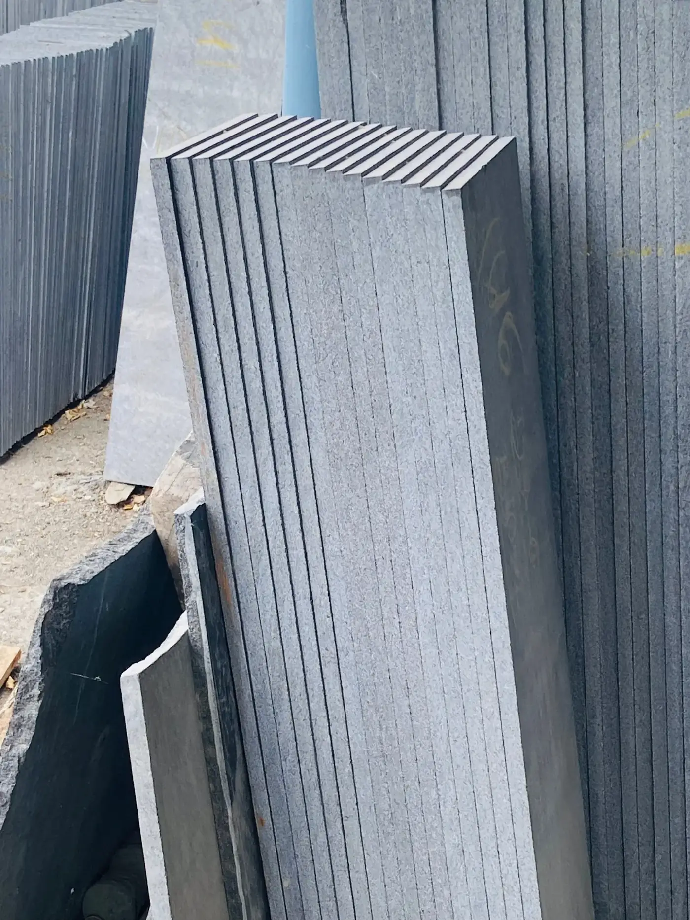 Bundled granite slabs staged for container loading