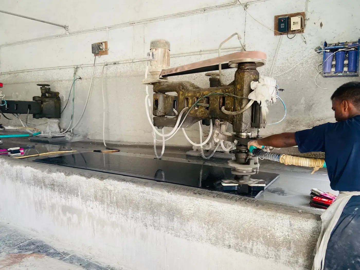 Craftsman hand-polishing an Absolute Black granite slab
